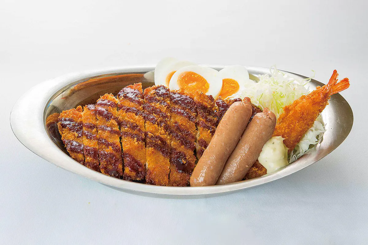 Japanese curry rice with tonkatsu, sausages, fried shrimp, boiled egg, and shredded cabbage at Go Go Curry, a Japanese Curry Restaurant in Gardena