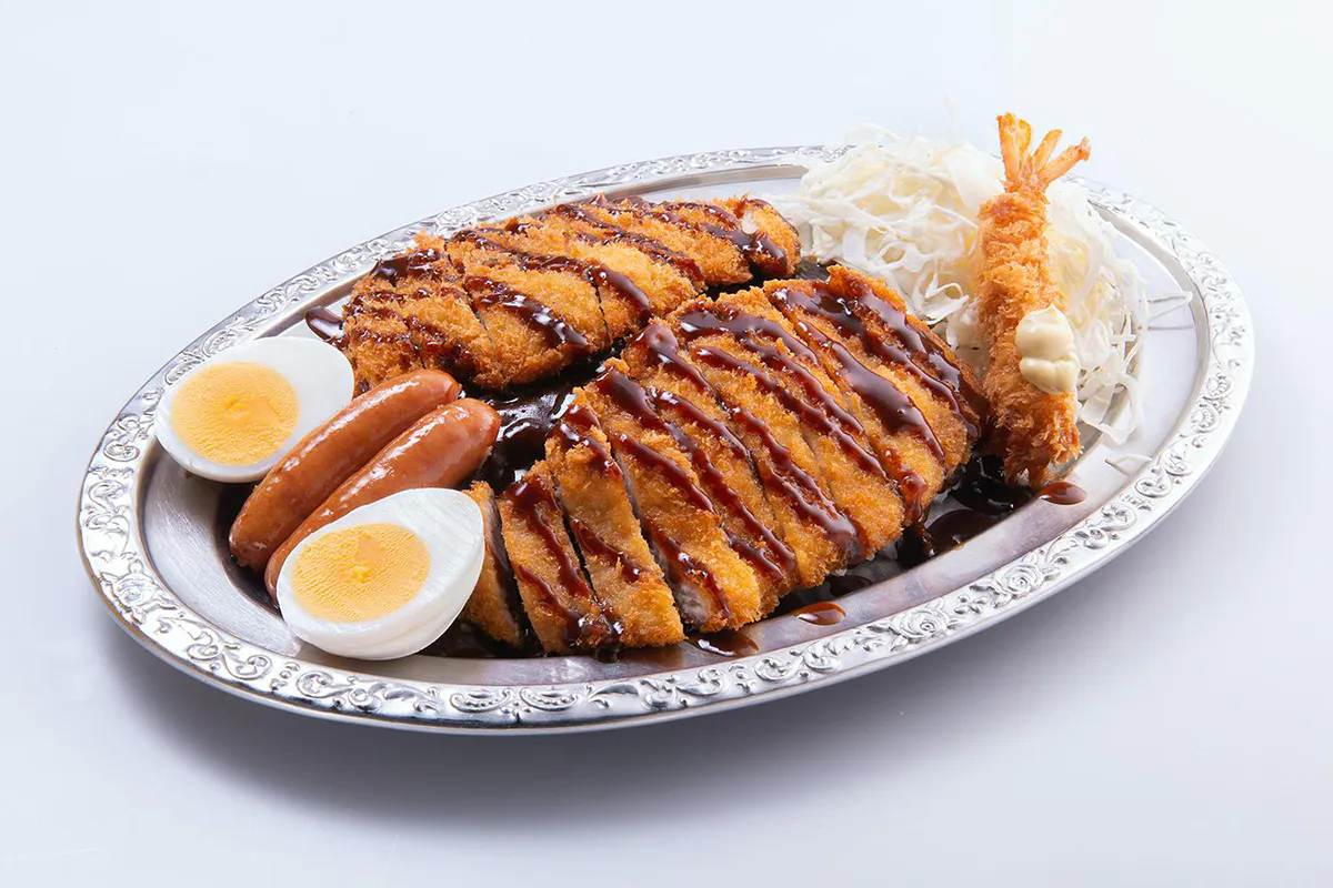 Japanese curry platter with double tonkatsu, fried shrimp, sausages, boiled egg, and cabbage at Go Go Curry, a Japanese Curry Restaurant in Gardena